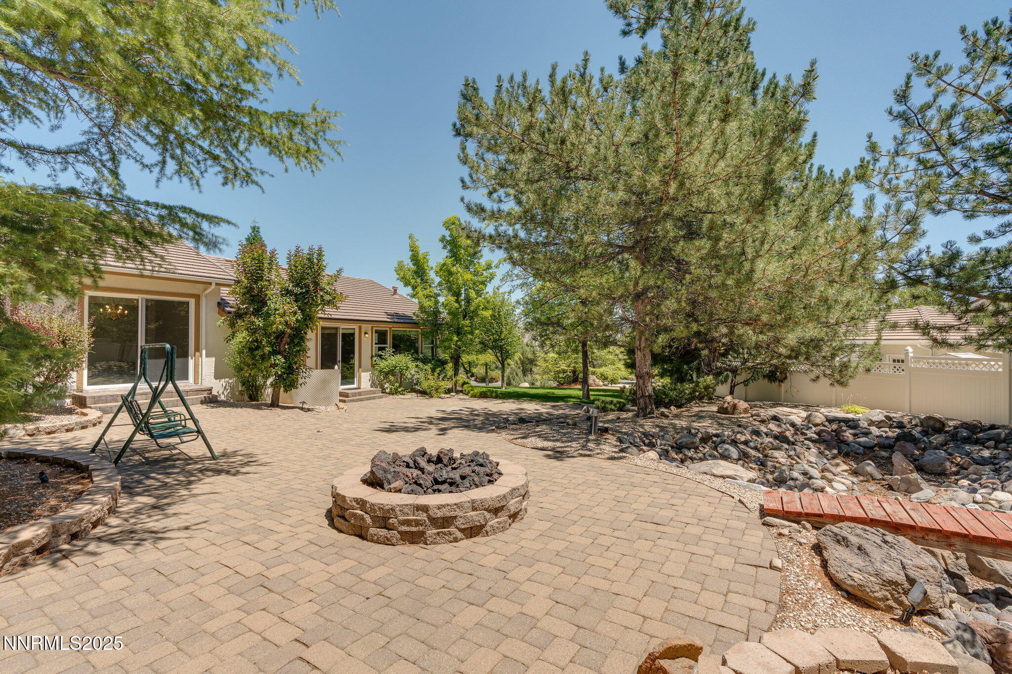 1300 Flanders Road Reno, NV 89511 - Photo 4 of 46 a view of a backyard with table and chairs under an umbrella