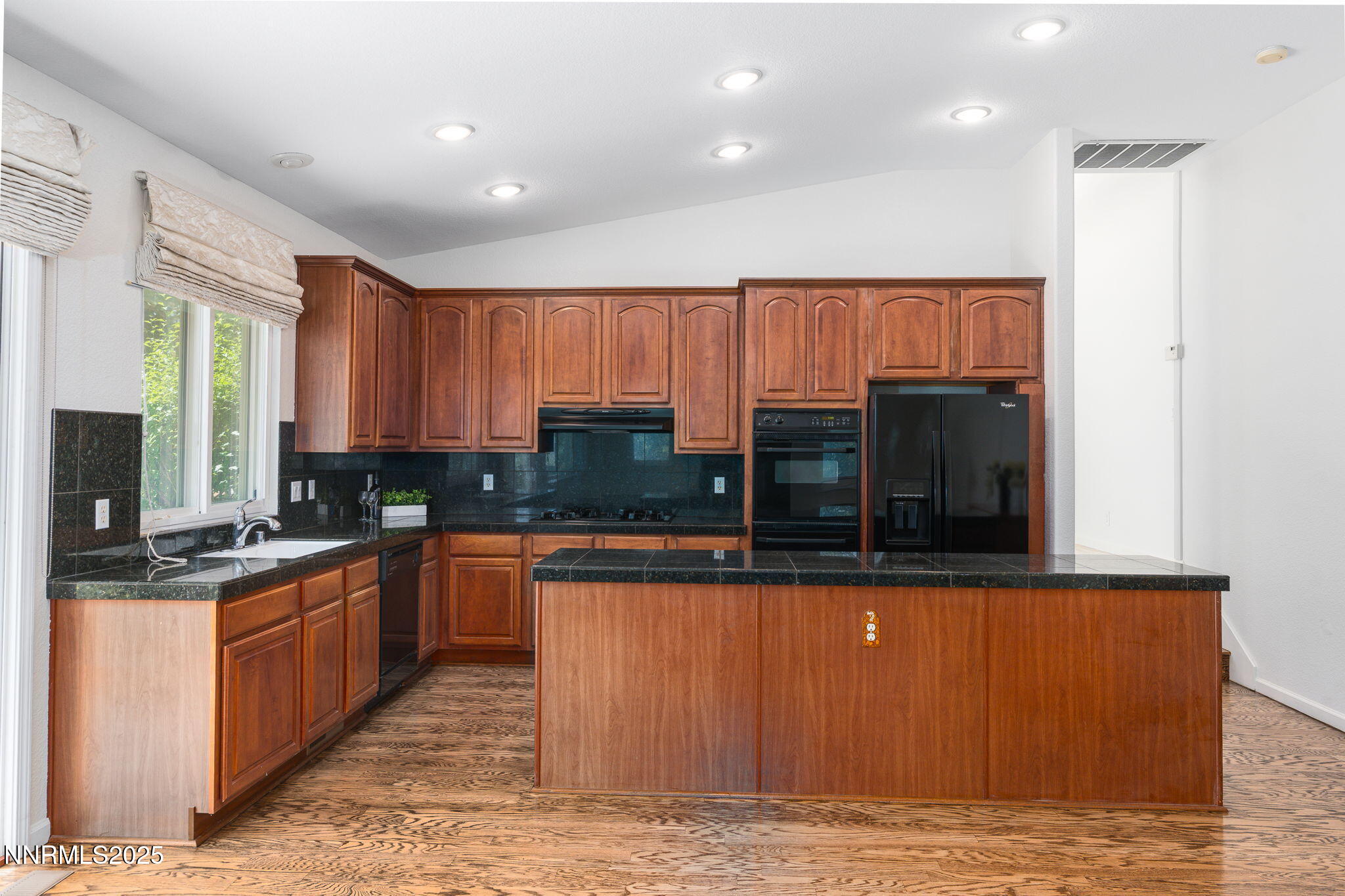 1300 Flanders Road Reno, NV 89511 - Photo 42 of 46 a kitchen with stainless steel appliances granite countertop a stove a sink and a microwave