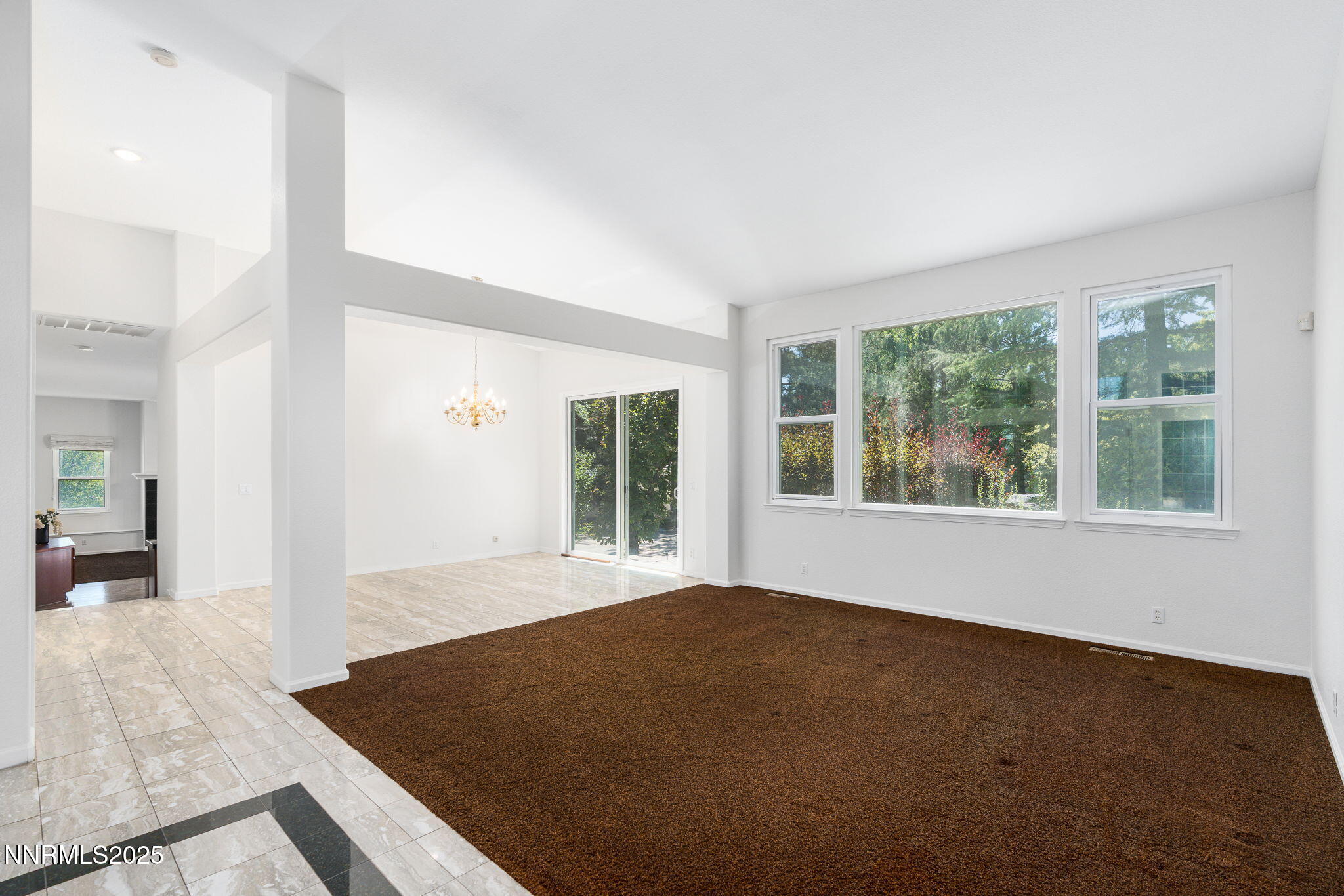 1300 Flanders Road Reno, NV 89511 - Photo 9 of 46 a view of an empty room with wooden floor and a window