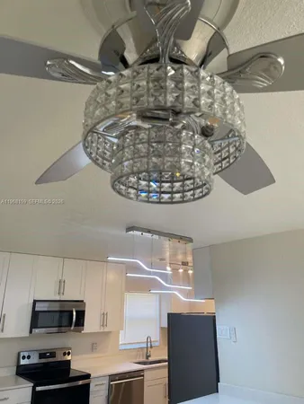 a kitchen with a sink a stove and a microwave