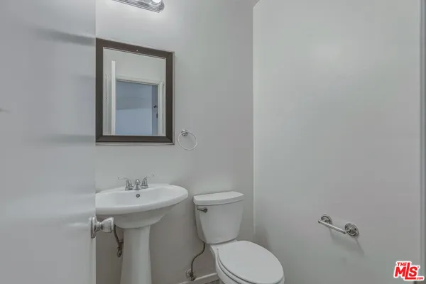 a view of a hallway with closet and mirror