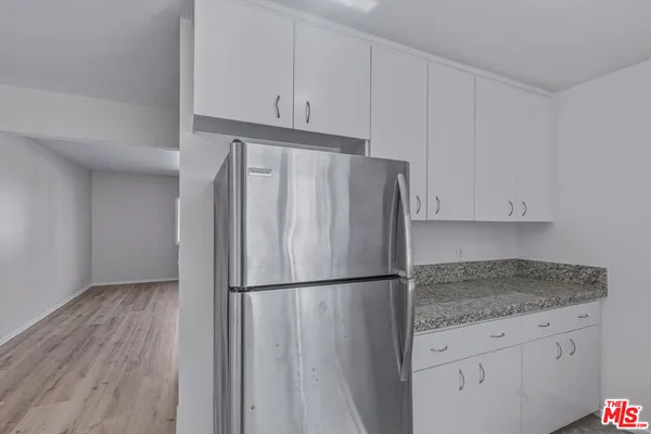 a kitchen with granite countertop a sink and a stove top oven