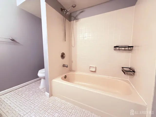 a white bath tub sitting next to a white toilet