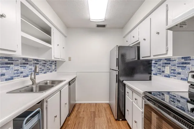 a kitchen with a sink stove and refrigerator