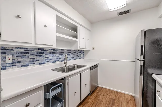 a kitchen with a sink and cabinets