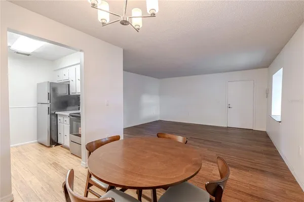 a view of kitchen with furniture and wooden floor