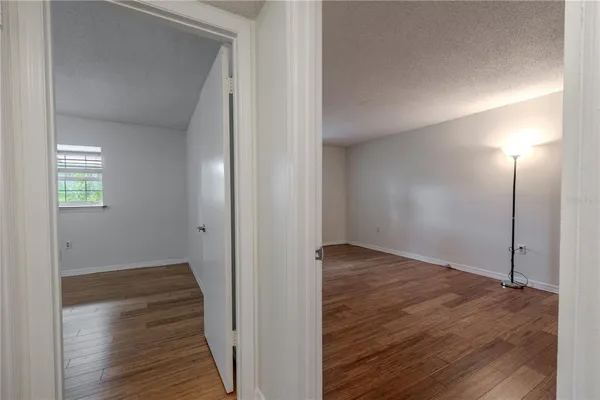 a view of a hallway with wooden floor