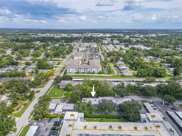 an aerial view of residential houses with outdoor space and street view