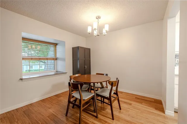 a view of a dining room with furniture and a chandelier