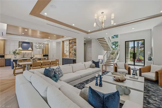 a living room with furniture and a chandelier