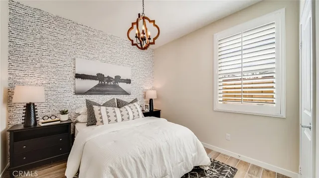 a bedroom with a bed and a chandelier