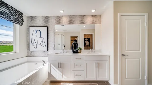 a bathroom with a bathtub a sink and a window