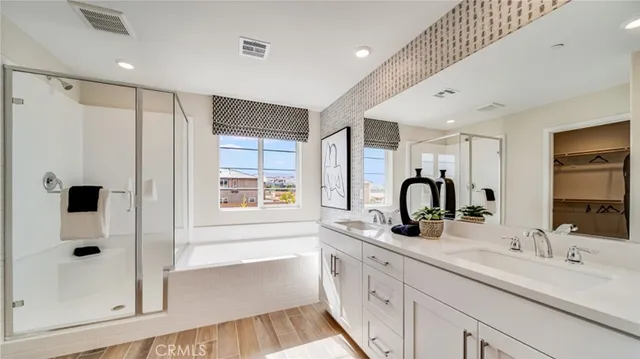 a bathroom with a double vanity sink a mirror and shower