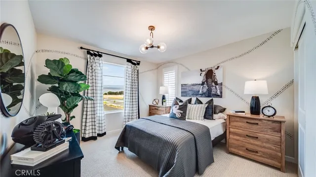 a bedroom with bed and a window