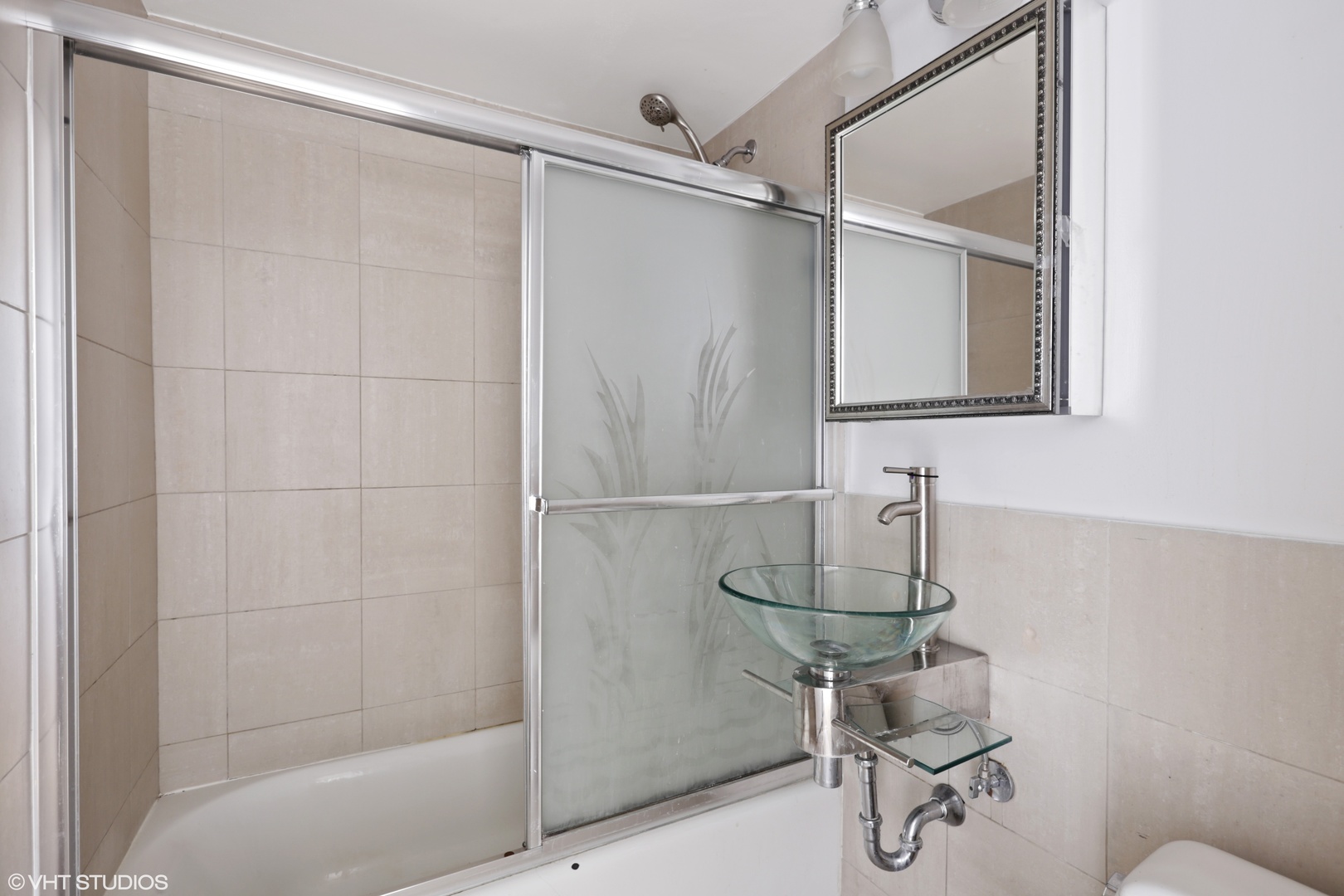 6301 North Sheridan Road, Unit 10L Chicago, IL 60660 - Photo 8 of 14 a bathroom with a shower and a mirror