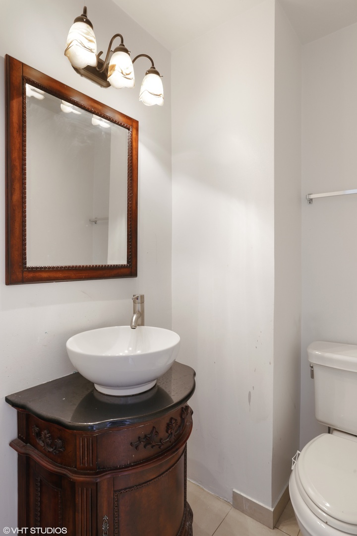 6301 North Sheridan Road, Unit 10L Chicago, IL 60660 - Photo 9 of 14 a bathroom with a toilet sink and mirror