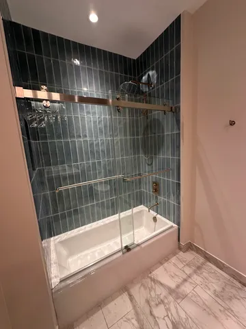 a bathroom with a shower and bathtub
