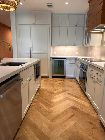 a kitchen with stainless steel appliances granite countertop a sink stove and cabinets