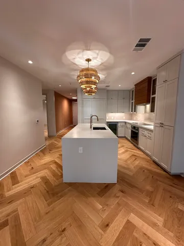 a living room with furniture and kitchen view