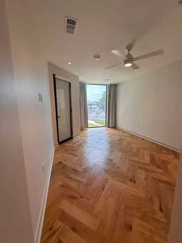 a view of a livingroom with a ceiling fan and window