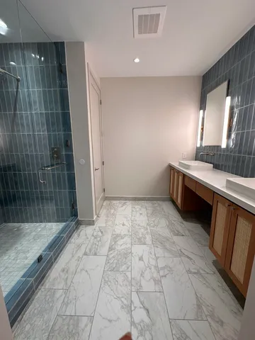 a view of a bathroom with a tub and shower