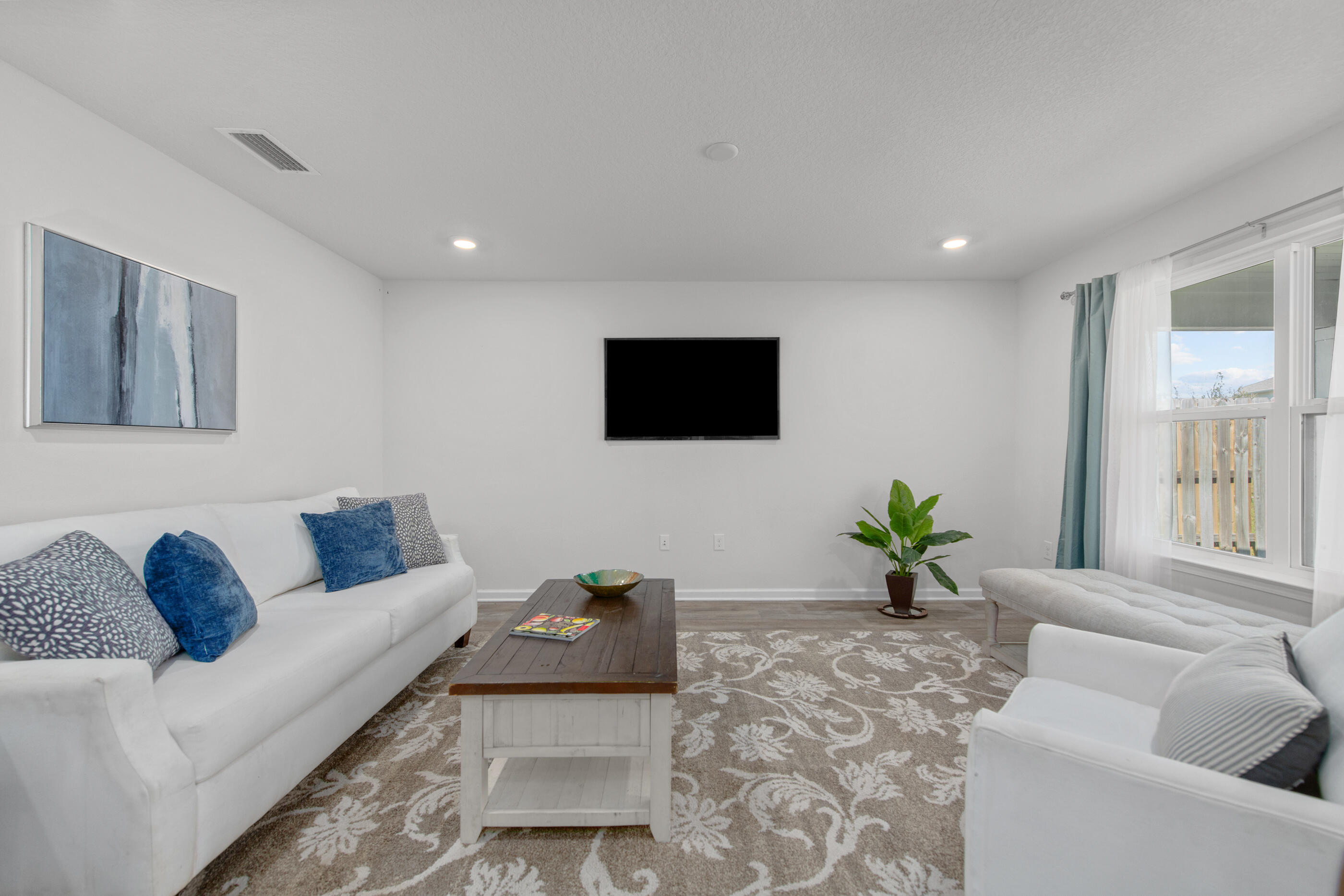 193 This Way Freeport, FL 32439 - Photo 23 of 56 a living room with furniture and a flat screen tv