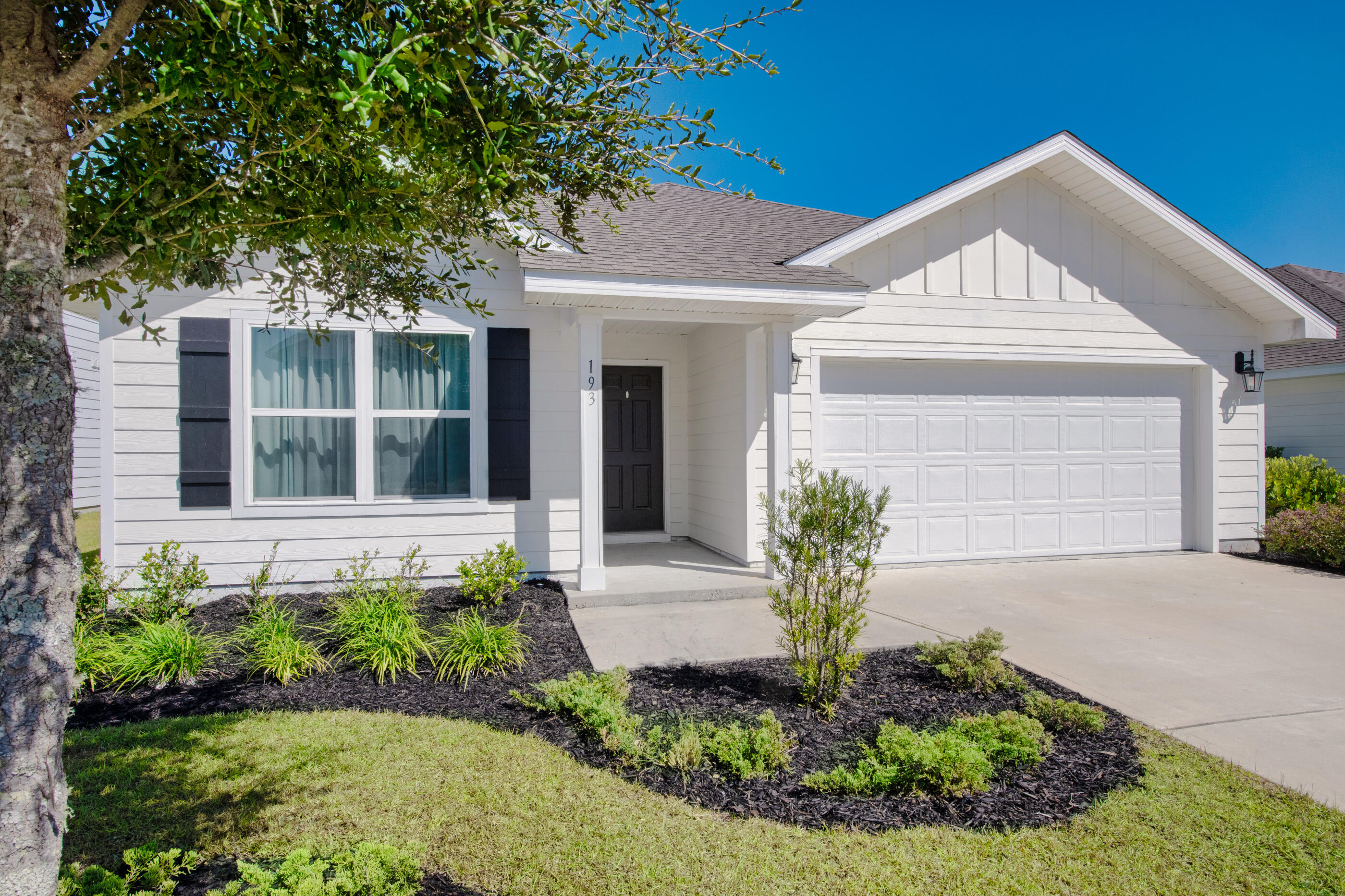 193 This Way Freeport, FL 32439 - Photo 3 of 56 a front view of a house with garden