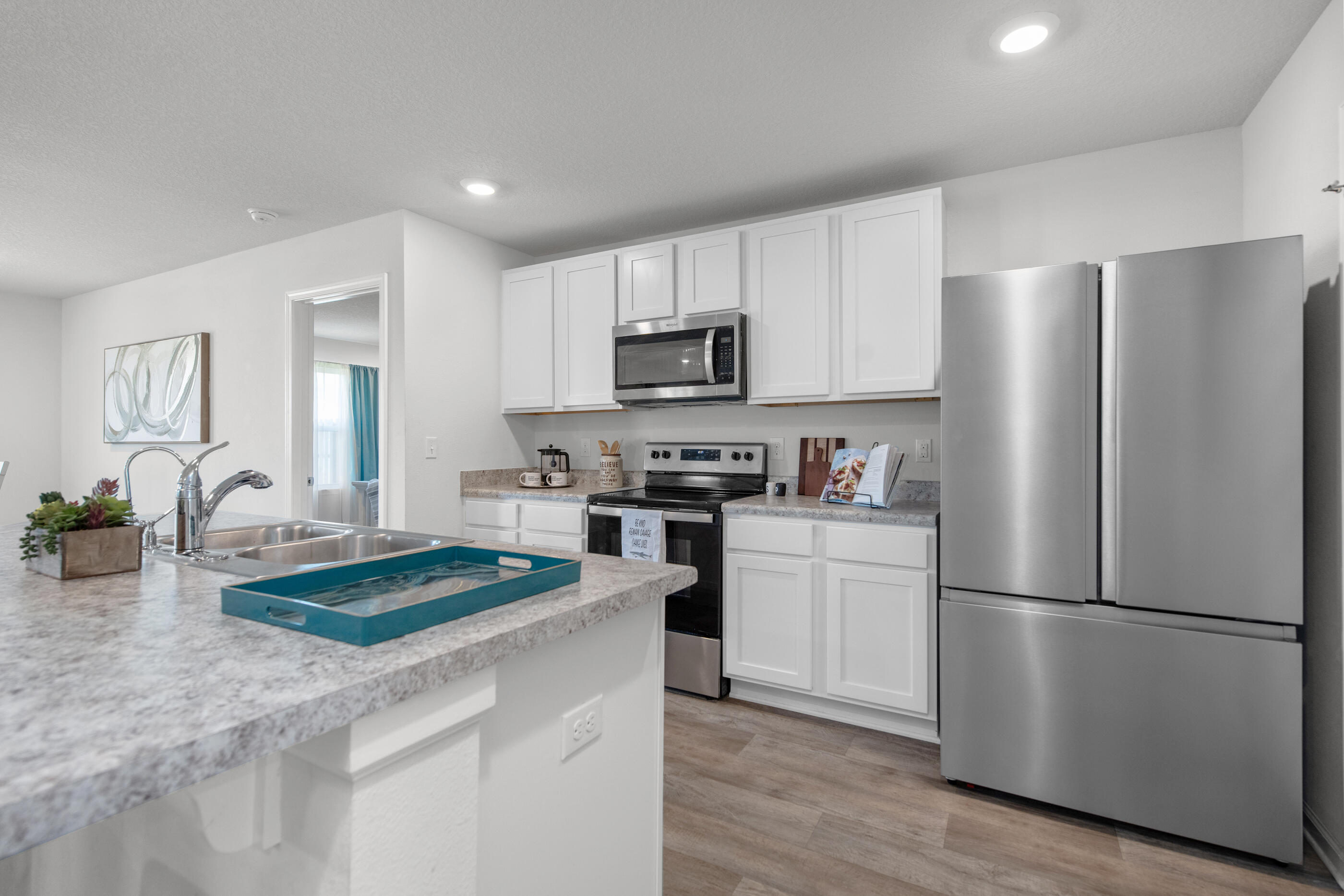 193 This Way Freeport, FL 32439 - Photo 6 of 56 a kitchen with granite countertop a refrigerator stove top oven and sink