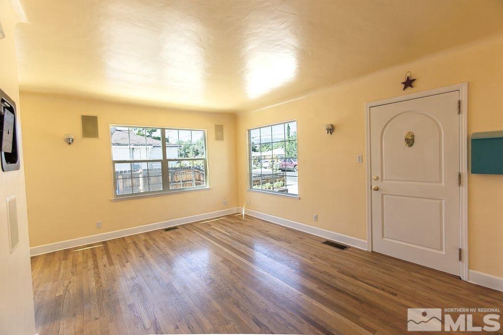 1290 Bon Rea Way Reno, NV 89503 - Photo 4 of 23 an empty room with wooden floor and windows