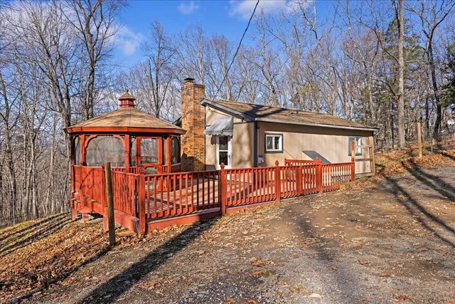 a view of a yard with wooden fence and a bench