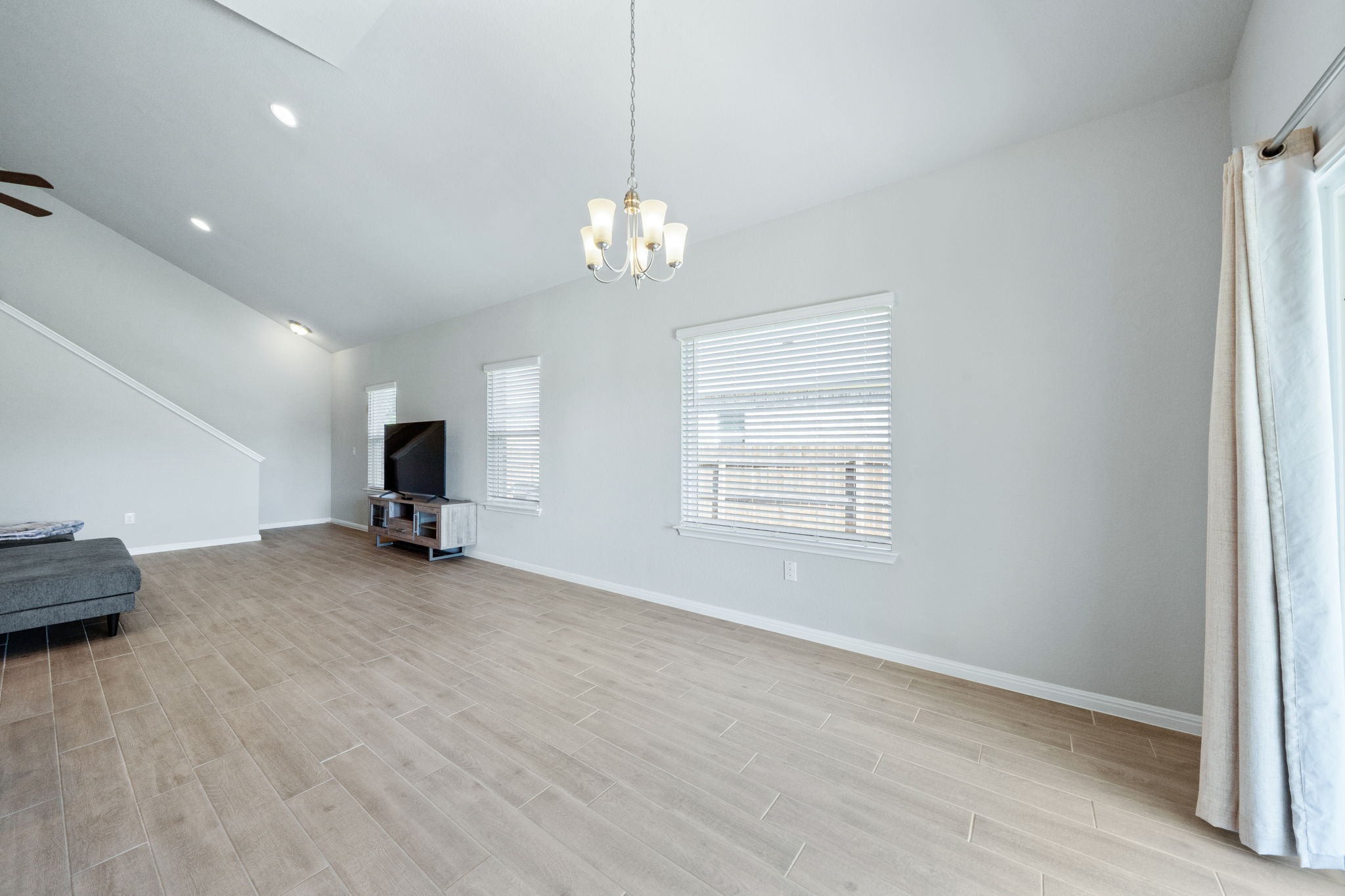 2412 Starhill Ranch Street Georgetown, TX 78628 - Photo 17 of 40 A comfortable great room awaits with ample light and sleek tile flooring.