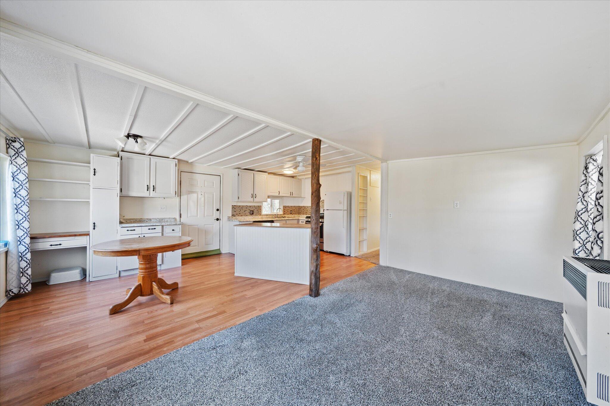 3150 Haley Lane Redding, CA 96003 - Photo 4 of 23 a room with kitchen island stainless steel appliances wooden floor and view living room