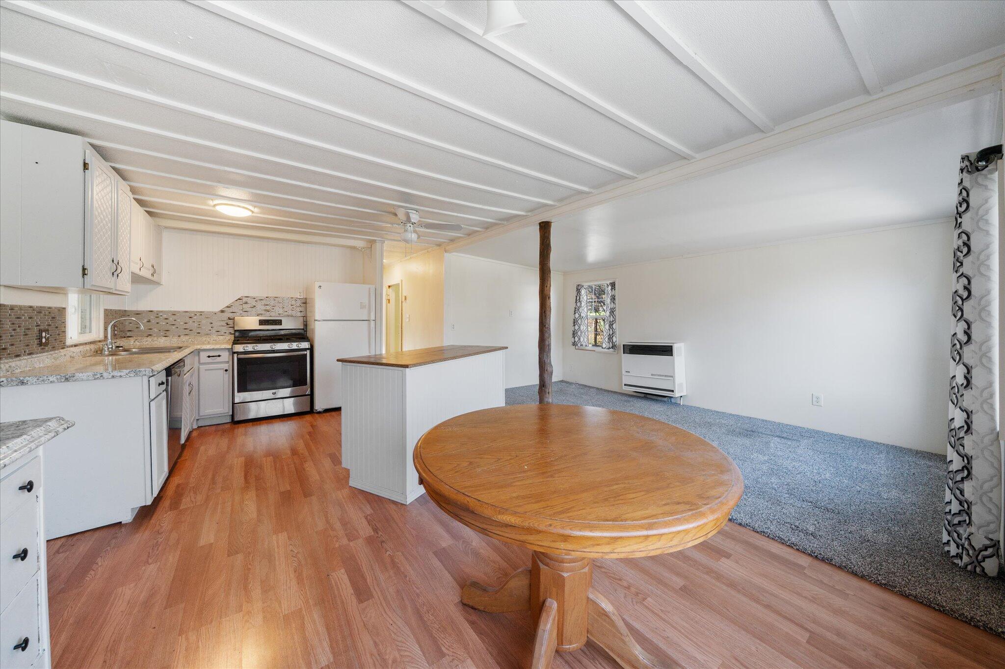 3150 Haley Lane Redding, CA 96003 - Photo 6 of 23 a room with wooden floor and furniture