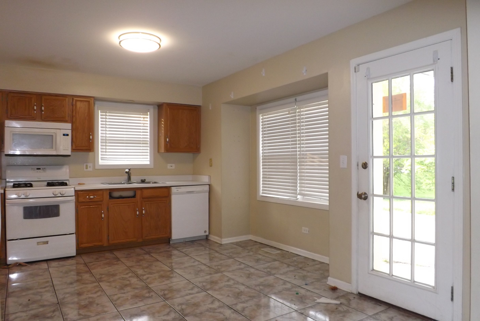 2325 Caton Corner Plainfield, IL 60586 - Photo 3 of 11 a kitchen with a stove a sink and a refrigerator