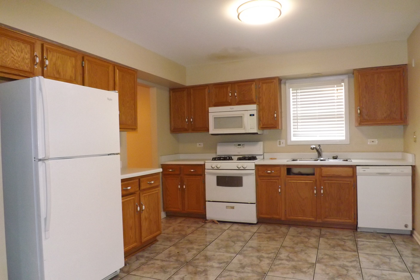 2325 Caton Corner Plainfield, IL 60586 - Photo 4 of 11 a kitchen with a white cabinets and white appliances