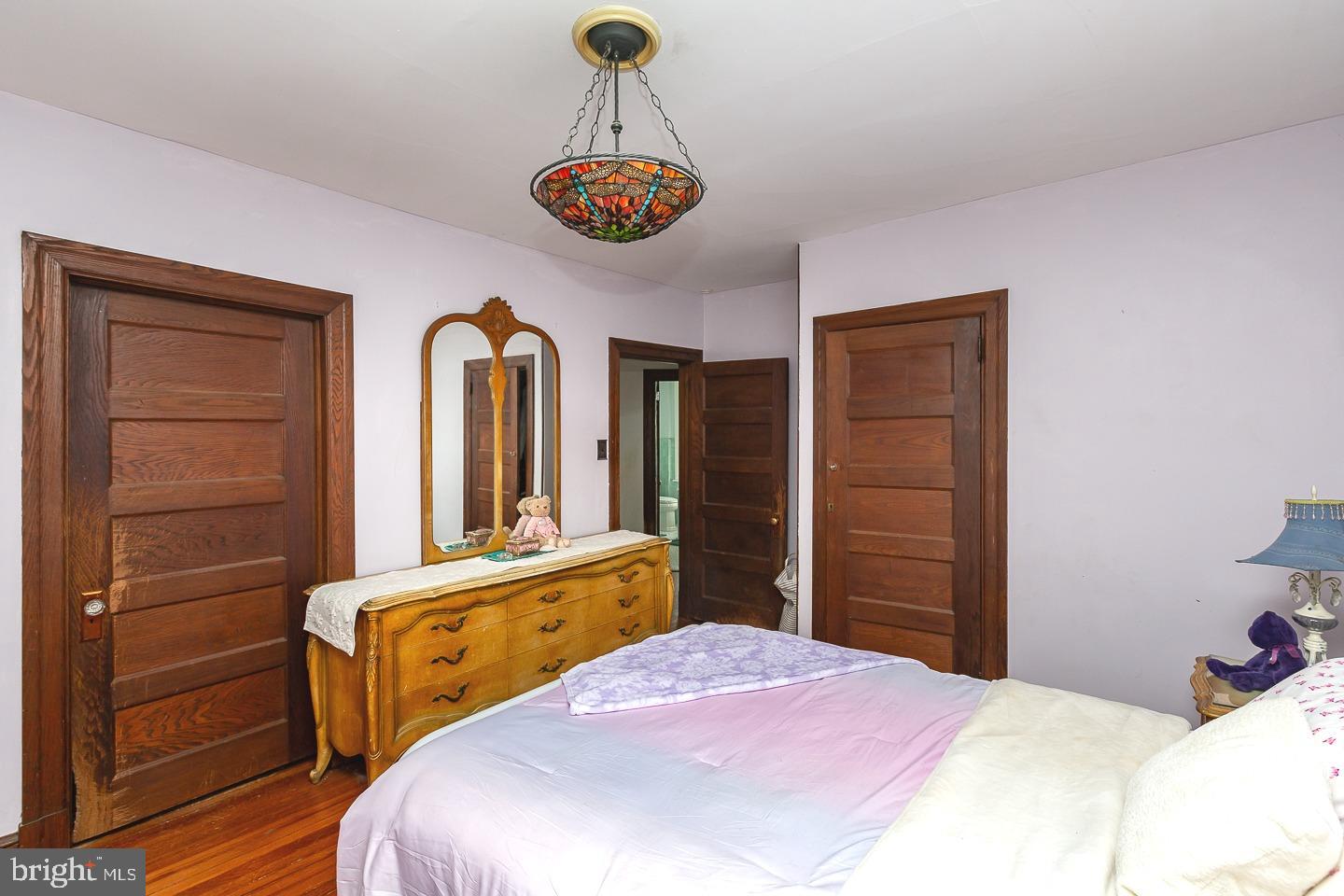 251 Sagamore Road Havertown, PA 19083 - Photo 21 of 41 a bedroom with a bed and a chandelier