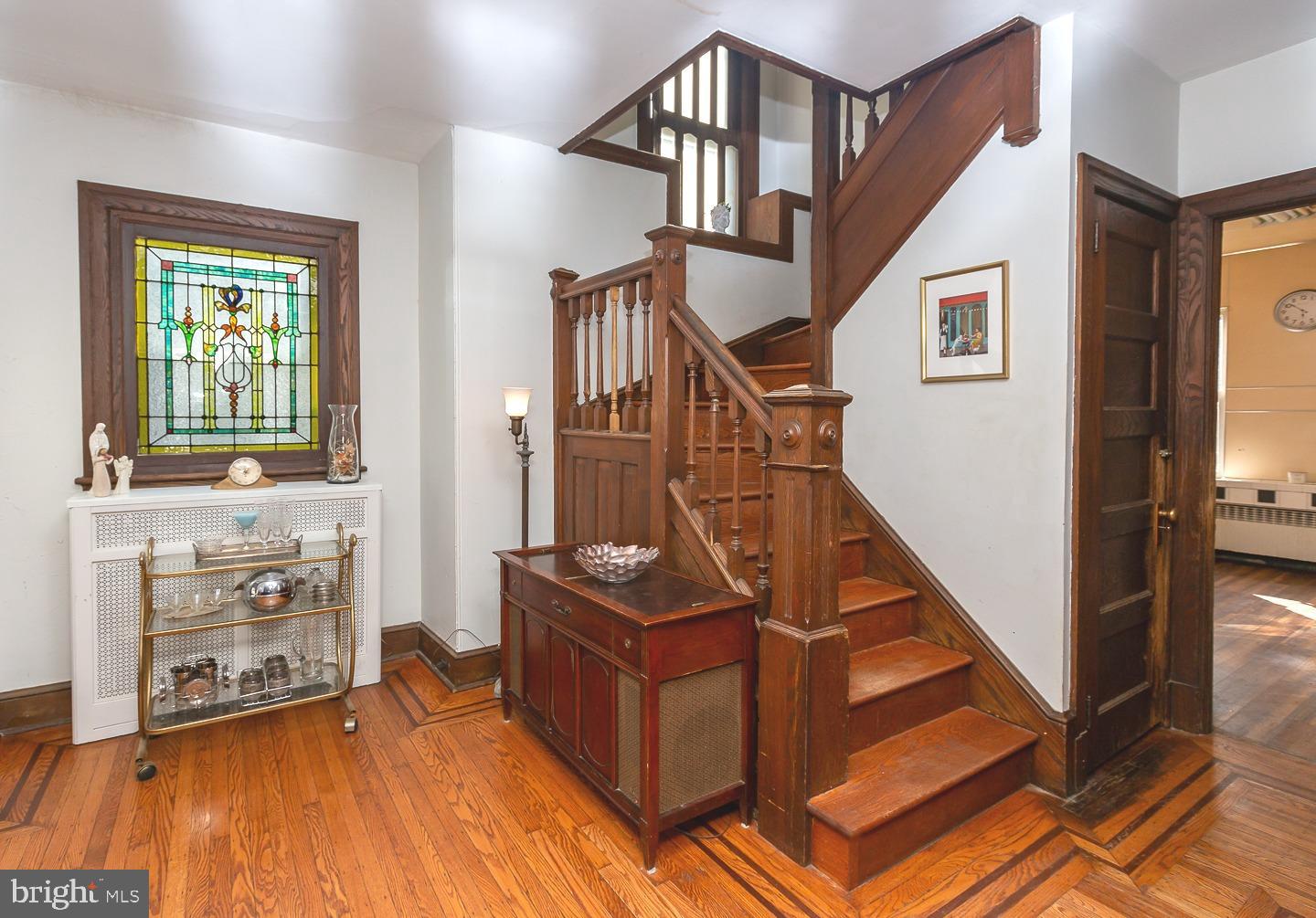 251 Sagamore Road Havertown, PA 19083 - Photo 5 of 41 a view of a livingroom with wooden floor and stairs