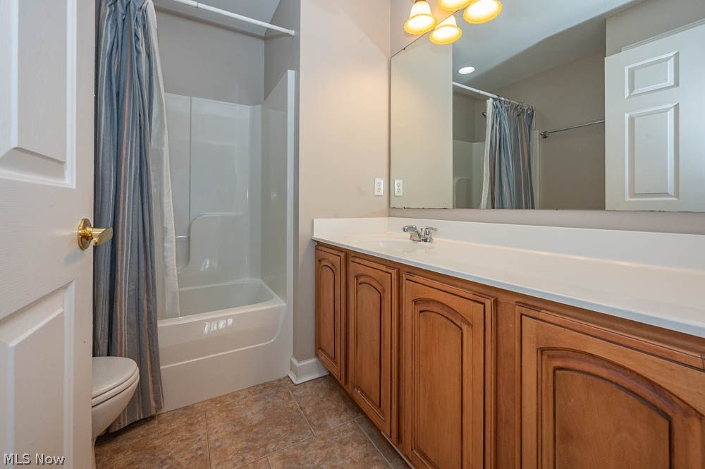 6787 South Palmyra Road Canfield, OH 44406 - Photo 19 of 30 Bathroom featuring a built-in wood-finish vanity with ample storage, a white countertop, and a large wall-mounted mirror