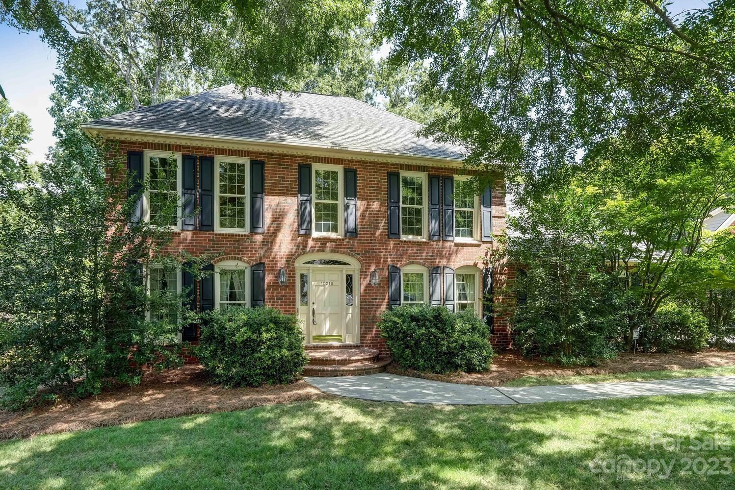 10215 Hanover Glen Road Charlotte, NC 28210 - Photo 1 of 40 a front view of a house with a yard