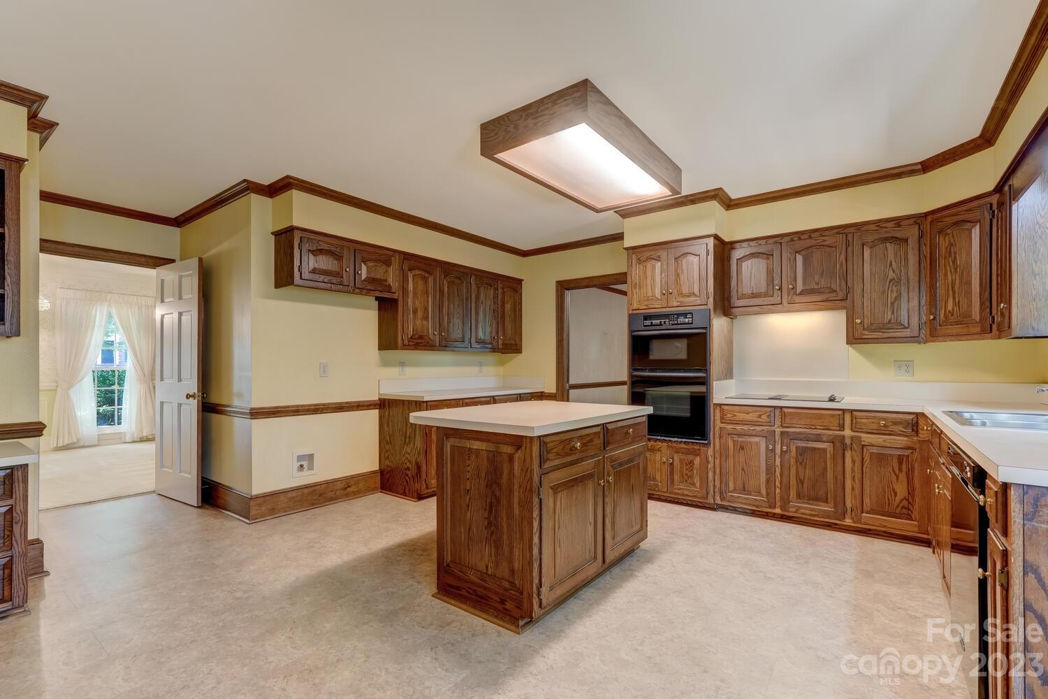 10215 Hanover Glen Road Charlotte, NC 28210 - Photo 14 of 40 a kitchen with stainless steel appliances granite countertop a stove and a refrigerator