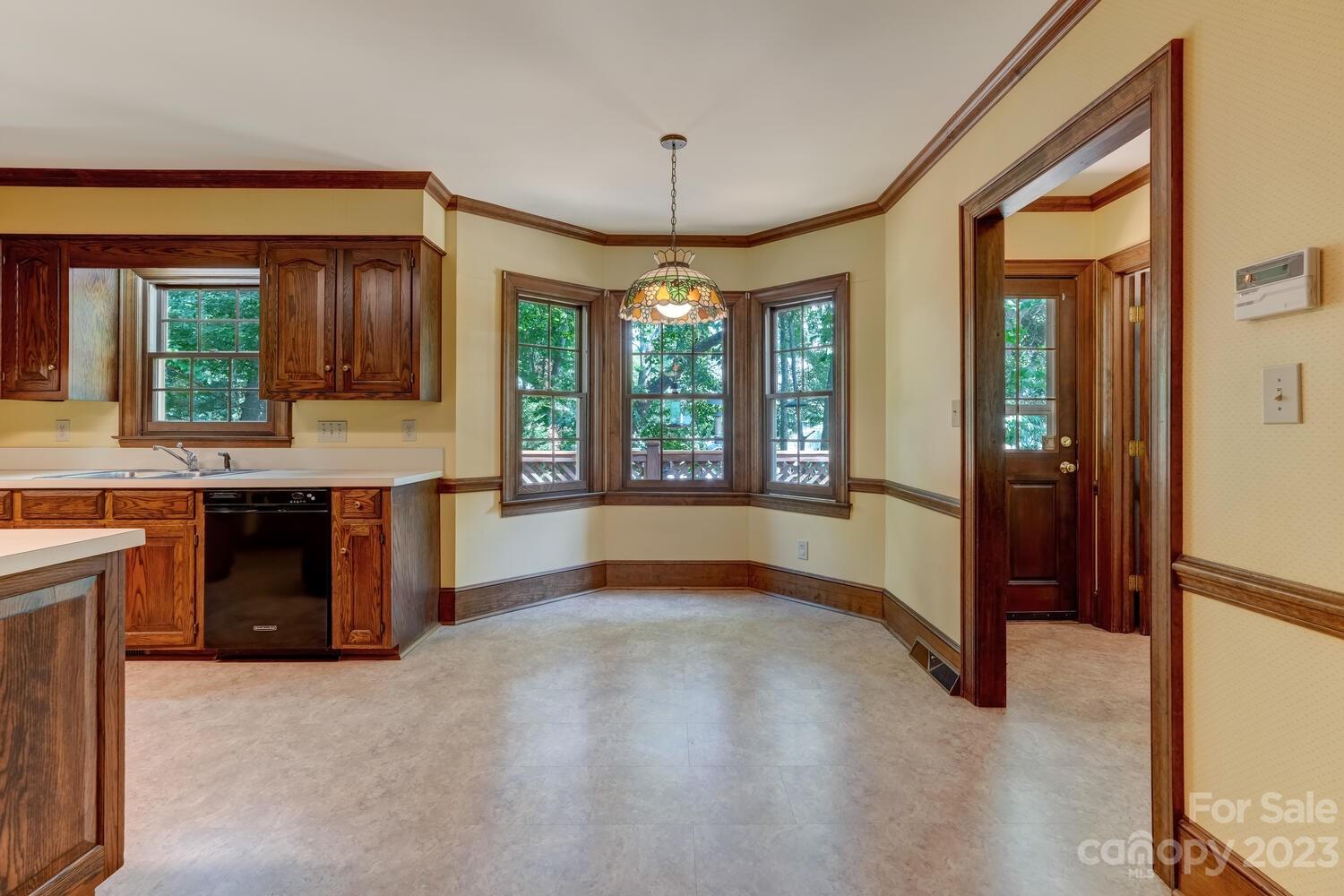 10215 Hanover Glen Road Charlotte, NC 28210 - Photo 15 of 40 a view of a kitchen with a sink and a large window