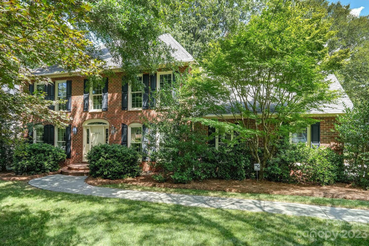 10215 Hanover Glen Road Charlotte, NC 28210 - Photo 2 of 40 a front view of a house with a yard