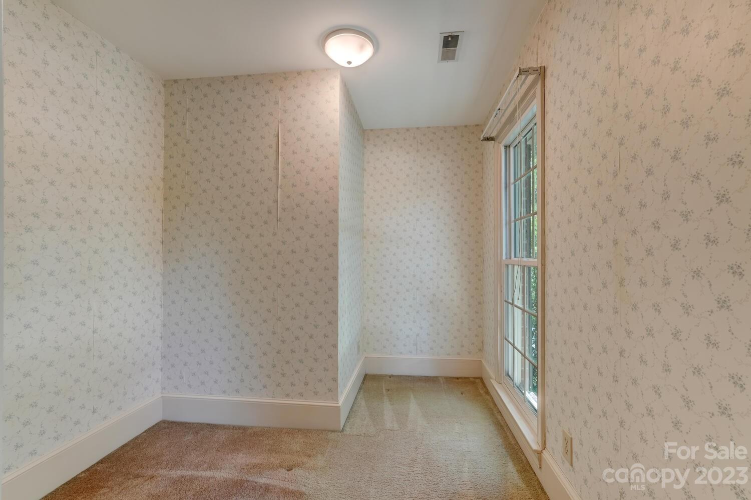 10215 Hanover Glen Road Charlotte, NC 28210 - Photo 24 of 40 an empty room with a empty space and windows