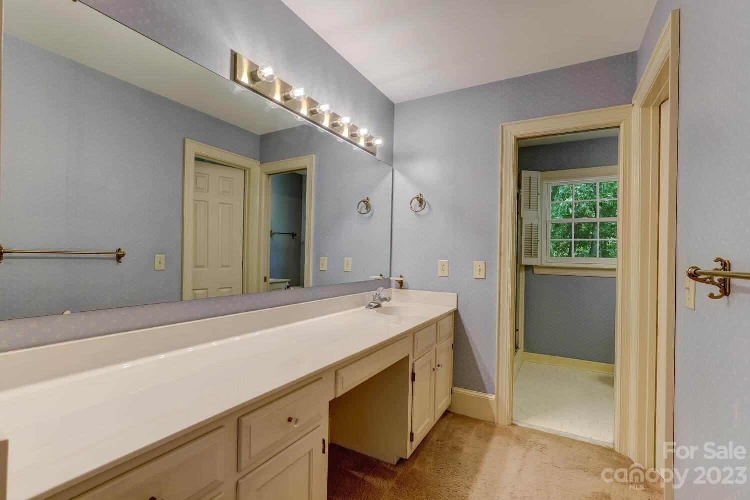 10215 Hanover Glen Road Charlotte, NC 28210 - Photo 26 of 40 a spacious bathroom with a sink and a mirror