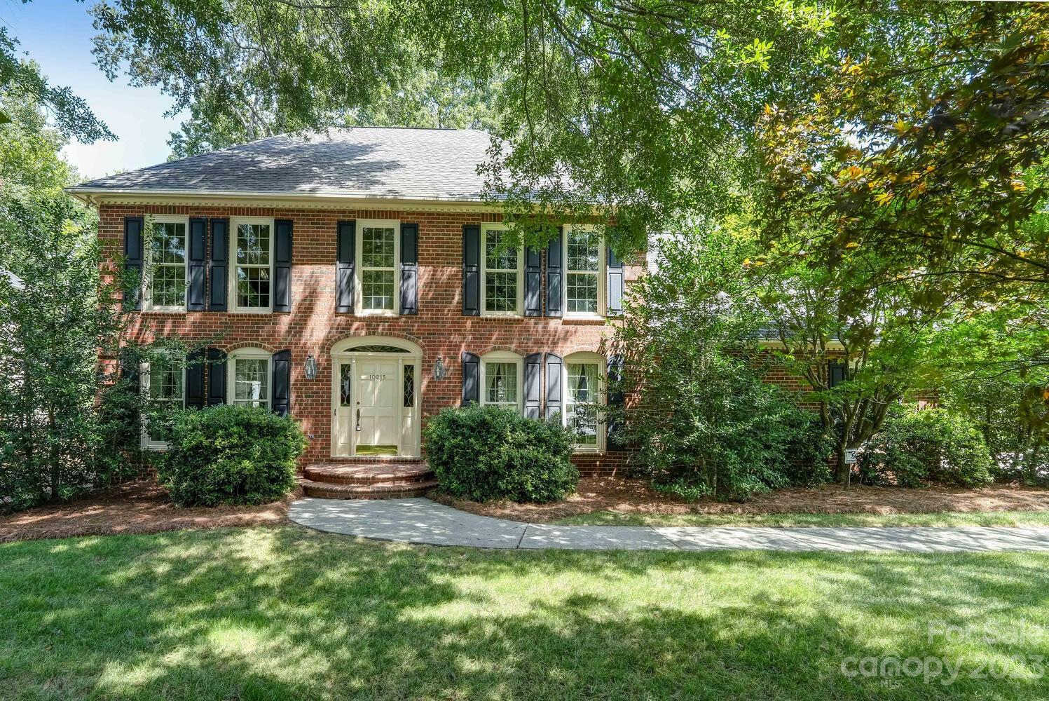 10215 Hanover Glen Road Charlotte, NC 28210 - Photo 3 of 40 a front view of a house with a yard