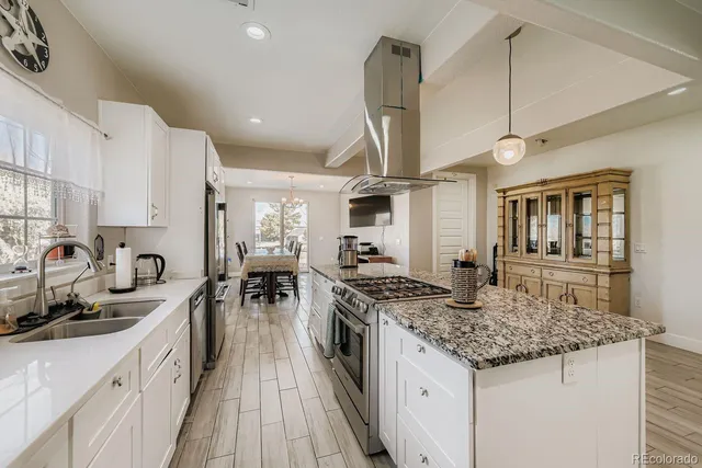 a kitchen with stainless steel appliances granite countertop a stove and a sink