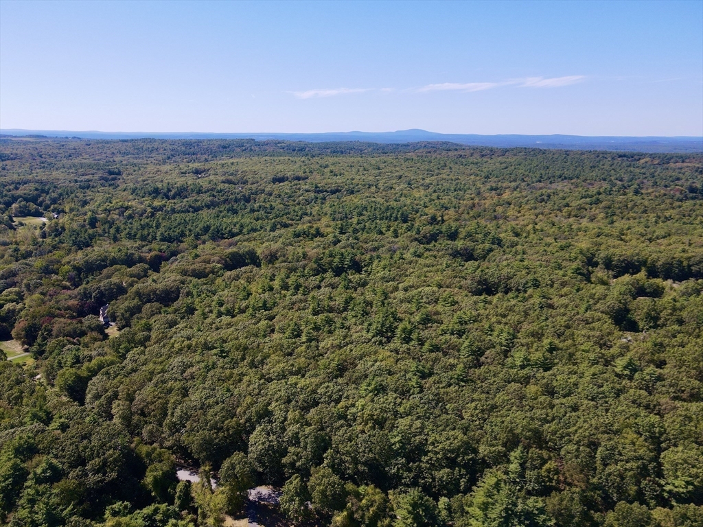 90 Corn Road Bolton, MA 01740 - Photo 9 of 11 an aerial view of residential houses with outdoor space and trees