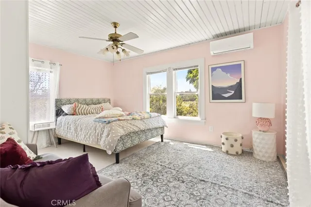 a living room with couches and painting on the wall