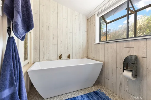a white bath tub sitting next to a window