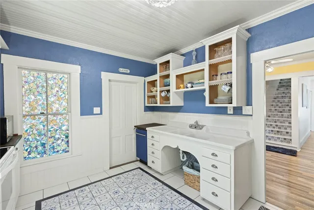 a living room with a baby crib furniture and a window